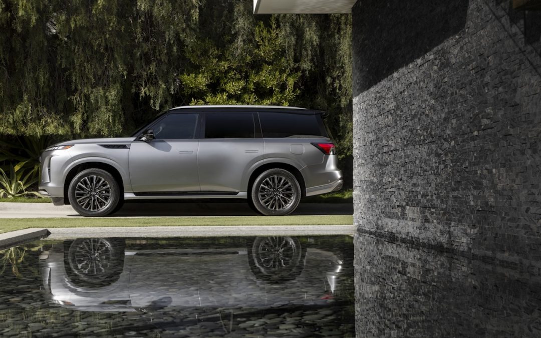 Silver INFINITI QX80 shown beside a modern home for luxury SUV maintenance and service near Franklin, TN